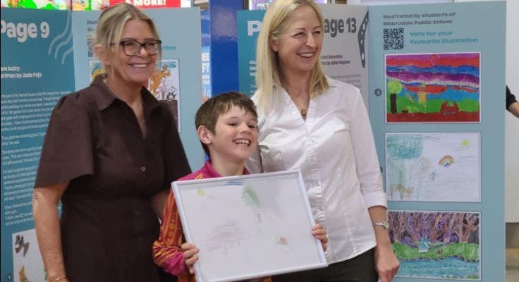 An image of a student receiving an award for his NAIDOC artwork